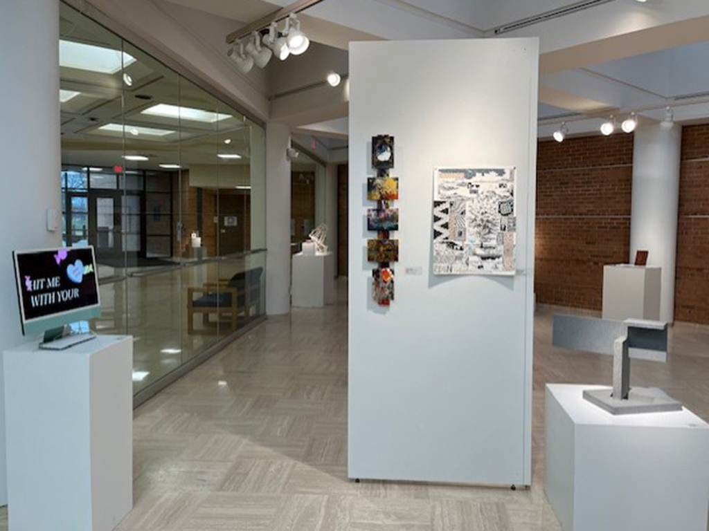 entry of the student show with various works of art